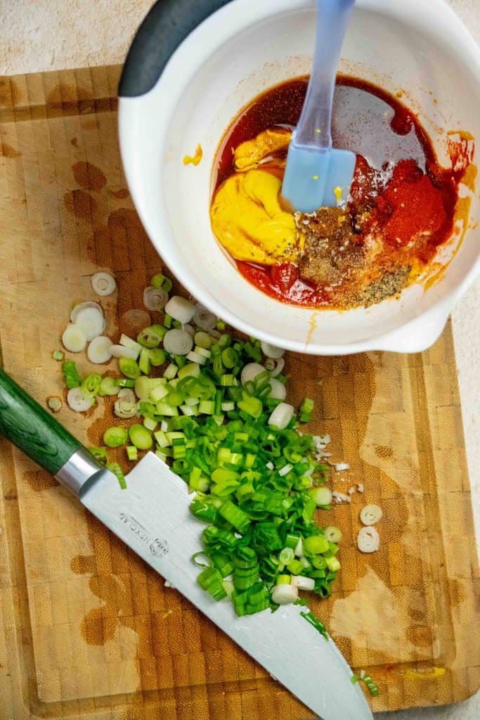 chop scallions, an add worcestershire, spices, mustard, molasses, vinegar, ketchup and brown sugar to a bowl