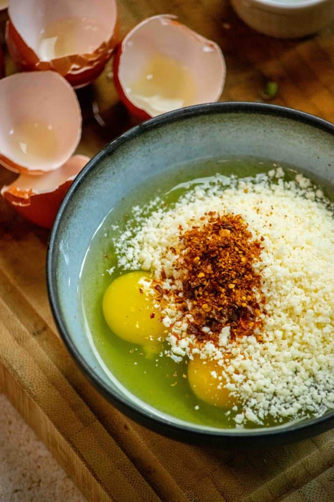 whisk together eggs, aleppo pepper, and parmesan