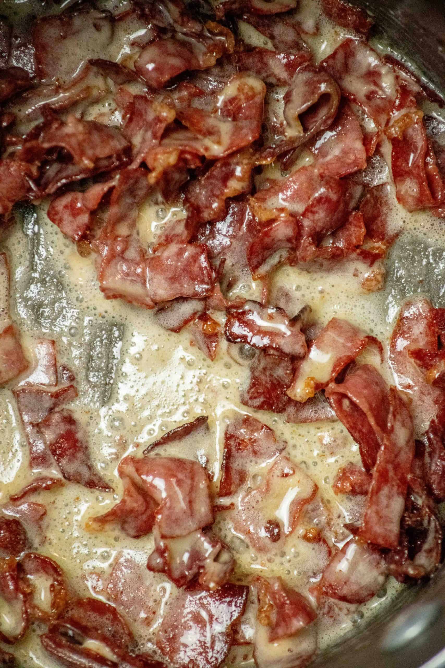 Adding the flour gradually to the skillet with the meat.