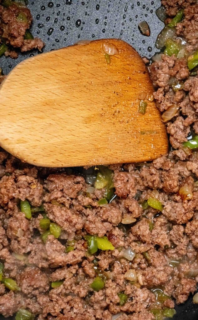 add ground beef, and cook until browned. Discard any excess fat. 