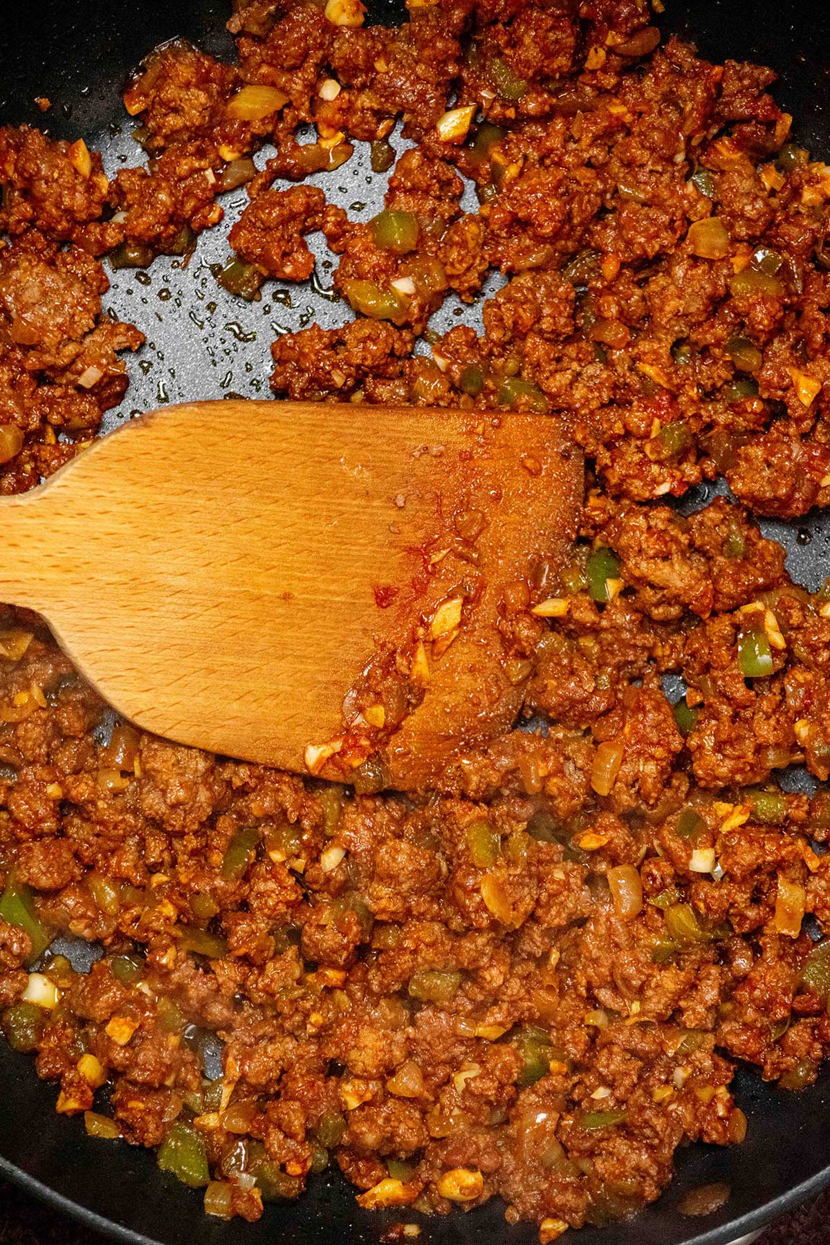 Brown the beef. Add the ground beef and cook until browned, breaking it up as it cooks. Drain off any excess fat, then stir in the garlic and tomato paste. Cook for about 3 minutes, until the tomato paste darkens slightly.
