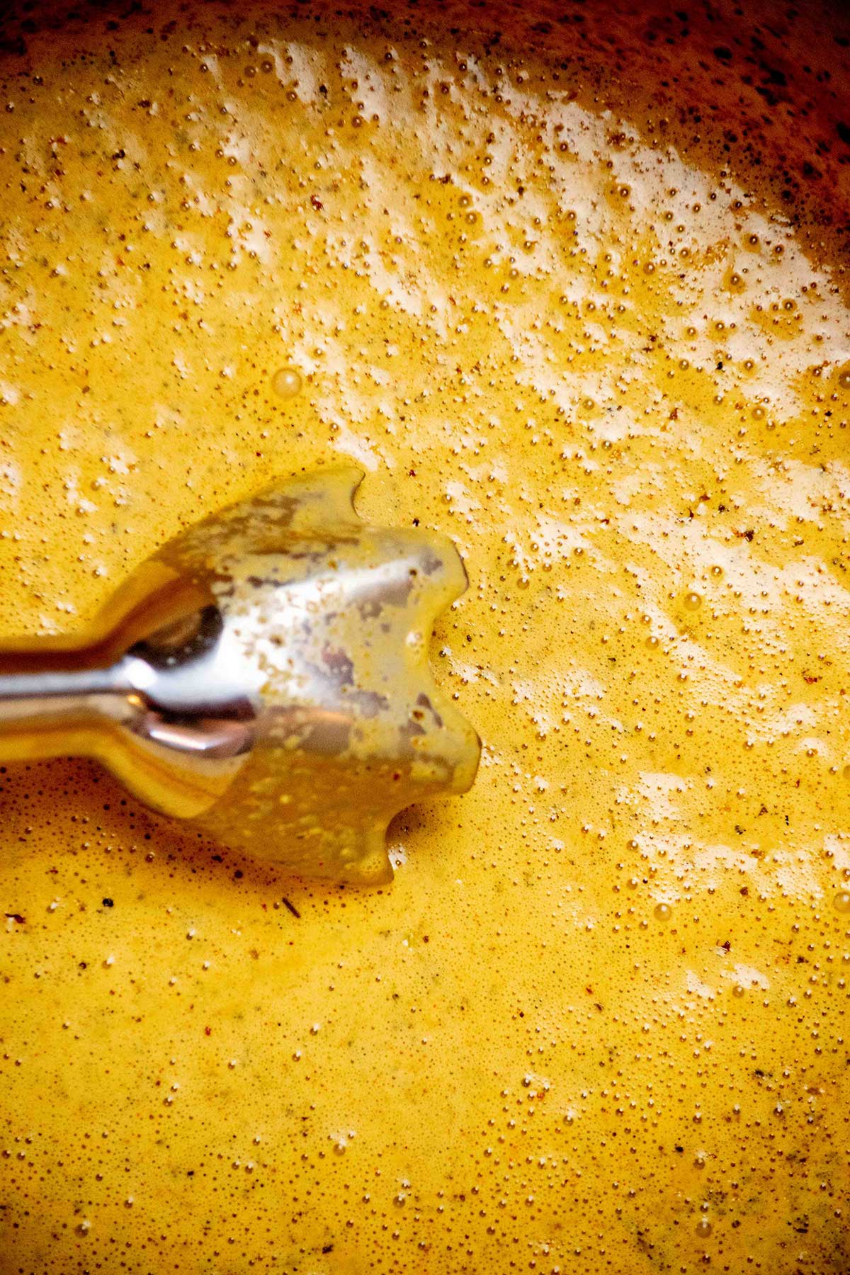 Simmer and blend. Simmer until the cream cheese is melted and the broth is creamy. Blend with an immersion blender until mostly smooth, leaving a little texture if you like.