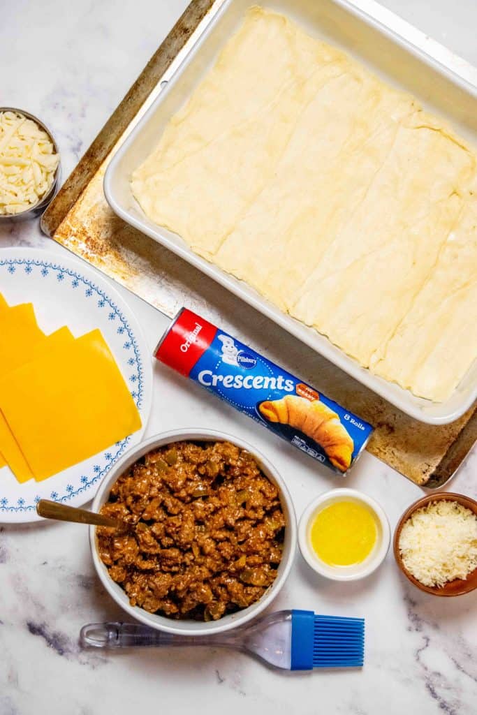 layer crescent rolls in even layer in bottom of greased baking dish, and press to seal edges