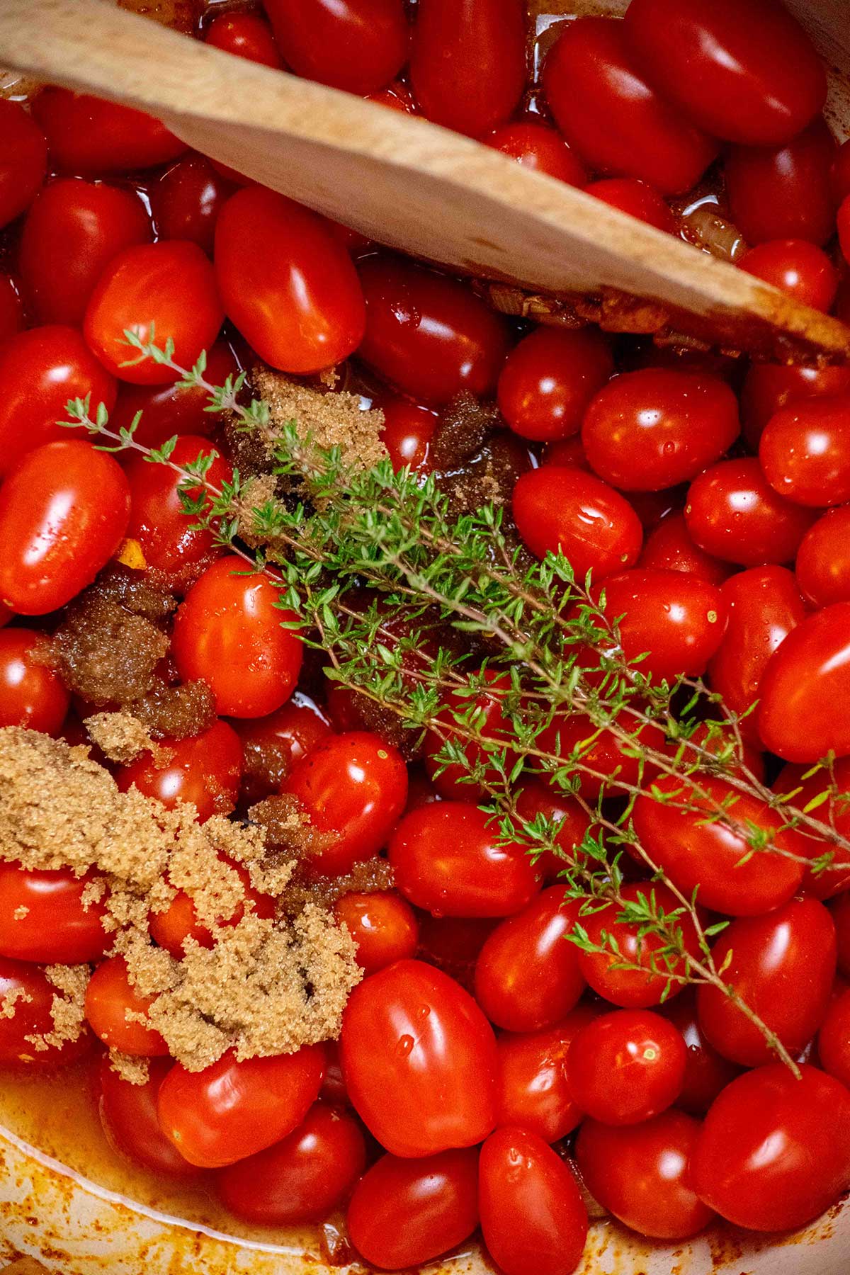 Add the tomatoes, thyme, brown sugar, and apple cider vinegar, and bring to a boil. 