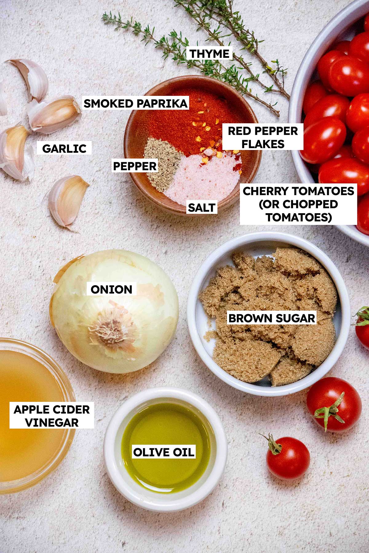 Tomato jam ingredients: tomatoes, brown sugar, olive oil, onion, garlic, thyme, spices, vinegar. 