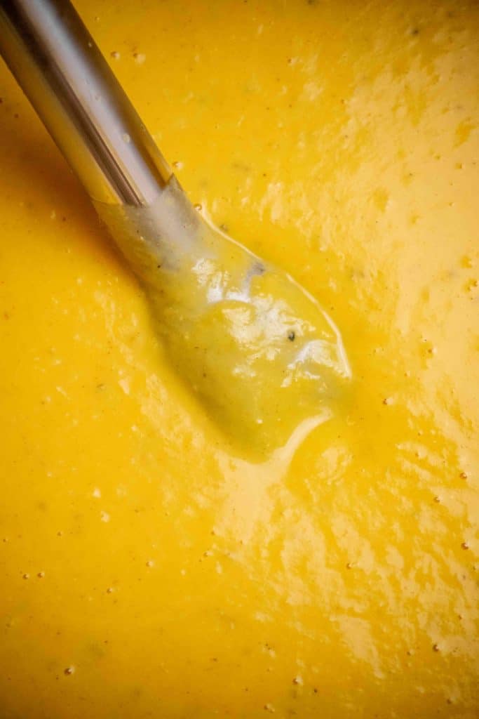 add coconut milk and nutmeg, warm through, and blend
