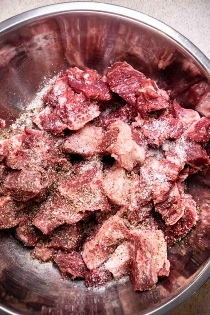 cut beef into 1" cubes, and season with salt and pepper