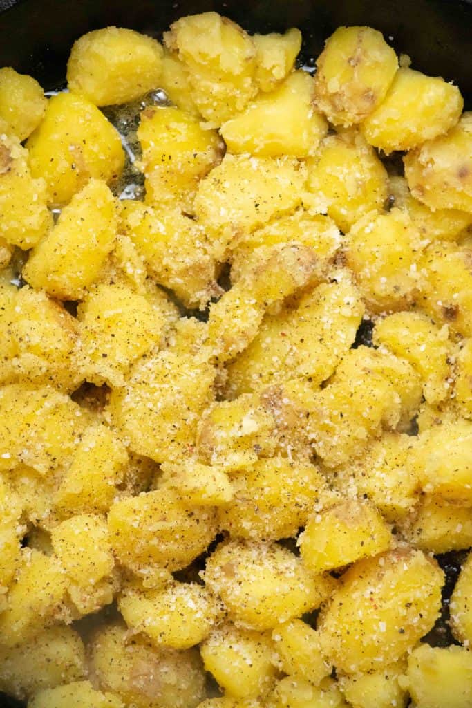 remove preheated cast iron skillet with duck fat from oven, spoon in potatoes in even layer, and season with salt and pepper