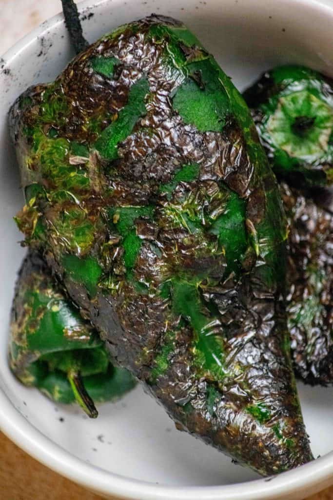 Roast peppers, steam, remove seeds and skin, and chop