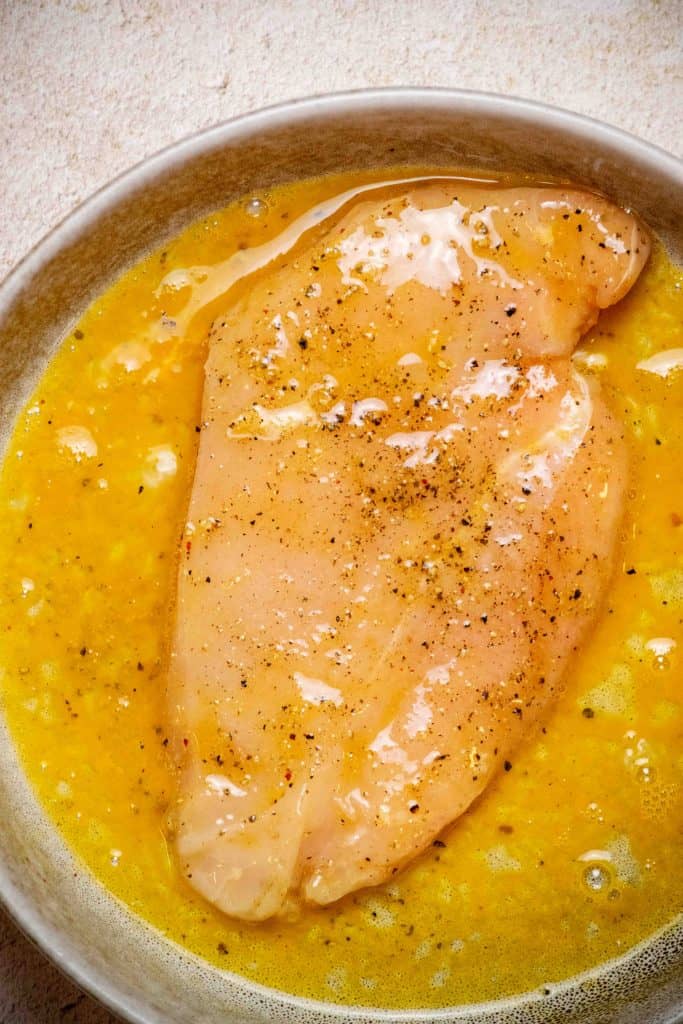 coat chicken in beaten egg 