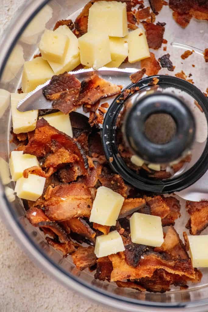 Add parmesan and cooked bacon to the food processor 