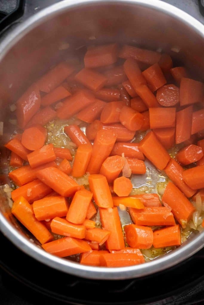 Sauté carrots and onion in coconut oil