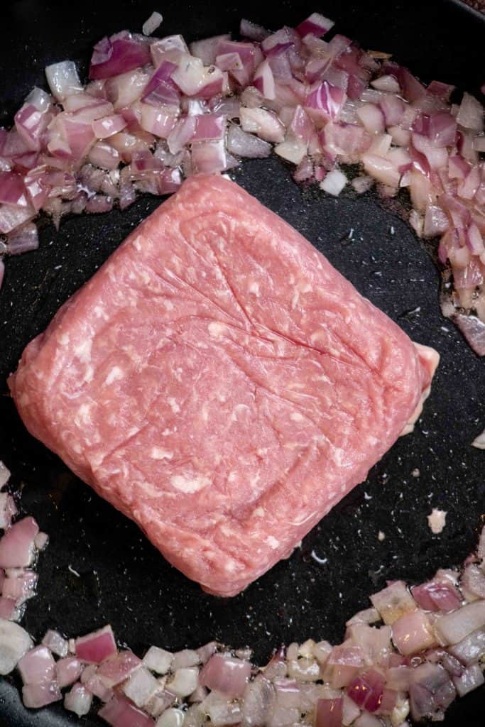 cook pork, breaking up as you go