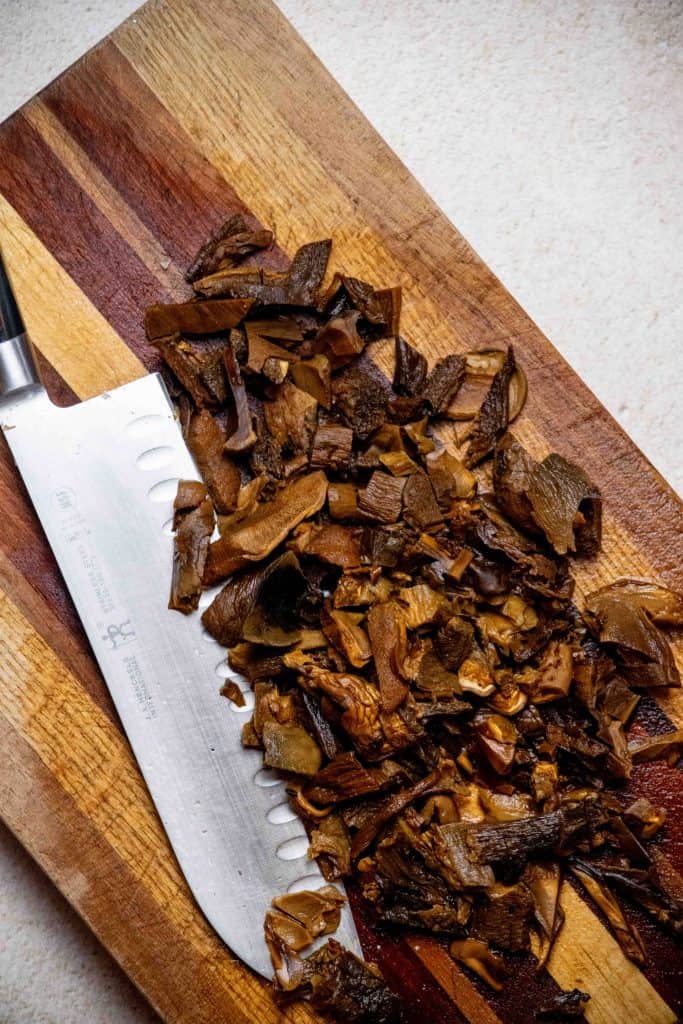 Remove porcinis from broth with a slotted spoon and allow to cool, the chop. Meanwhile, return heat on broth to low to keep warm. 