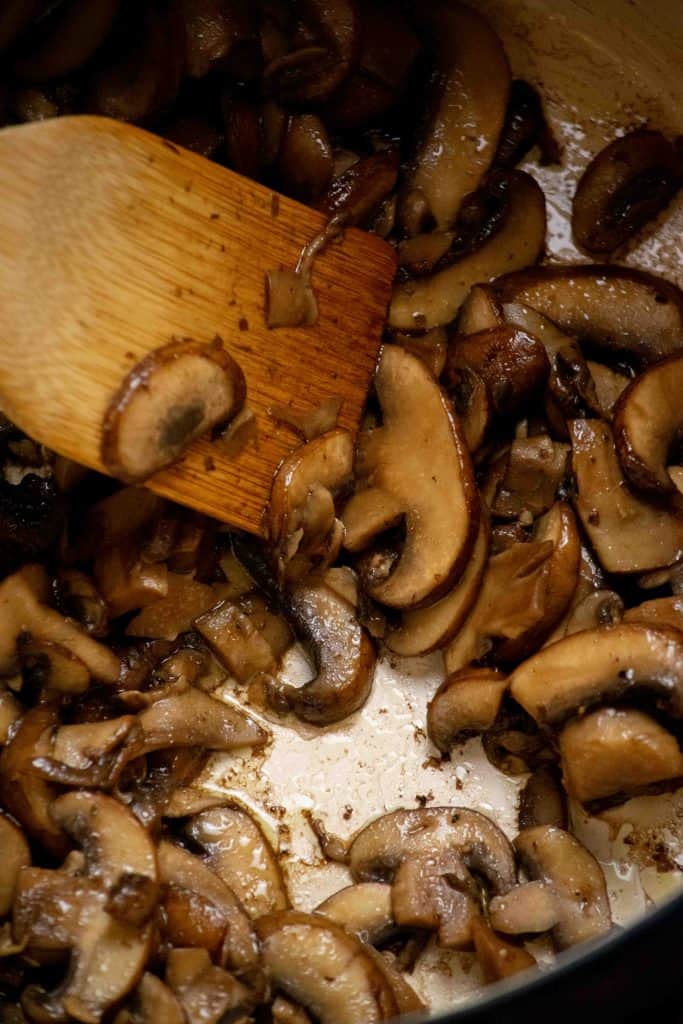 Cook sliced creminis in olive oil to remove their liquid and cook down, the remove to a plate.