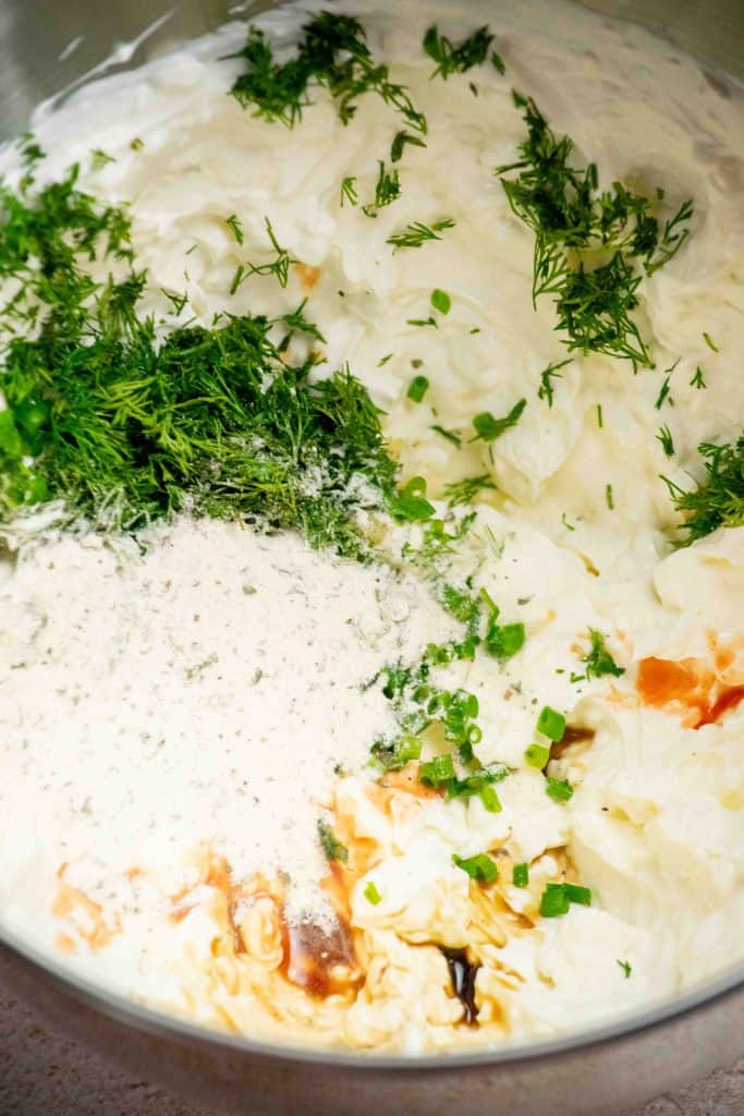 mix in dill, chives, Worcestershire sauce, hot sauce, ranch seasoning and pickle brine