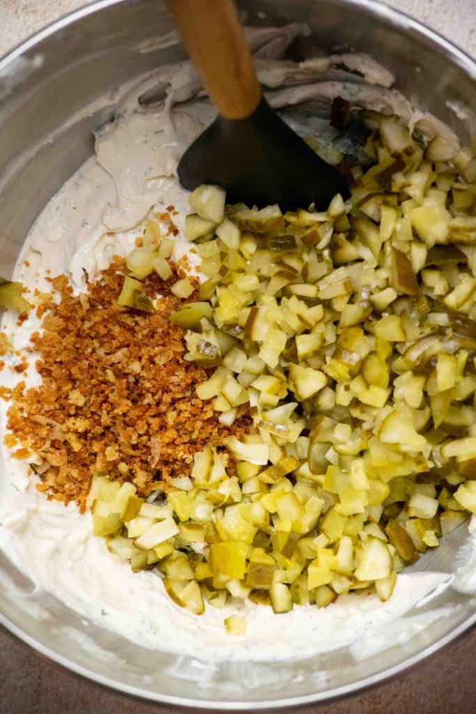 fold in pickles and half of the crispy topping
