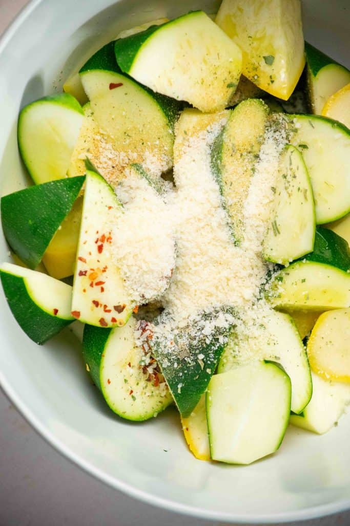 add to a large bowl with half the parmesan, spices, and olive oil