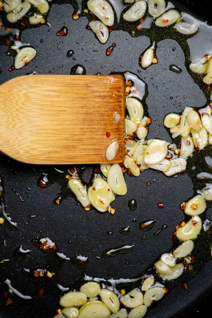 heat olive oil in a large skillet, and add garlic and red pepper flakes