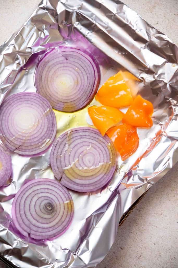 arrange onion slices and seeded habaneros on a foil lined sheet pan and drizzle with oil