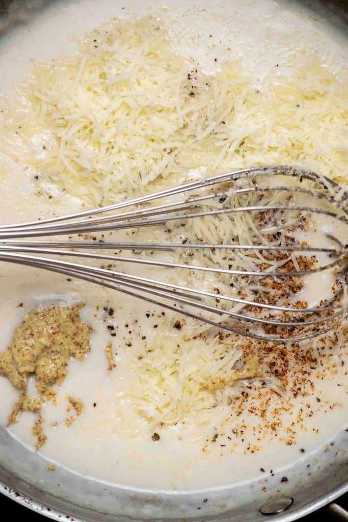 when sauce thickens, whisk in cheese, spices and dijon off heat