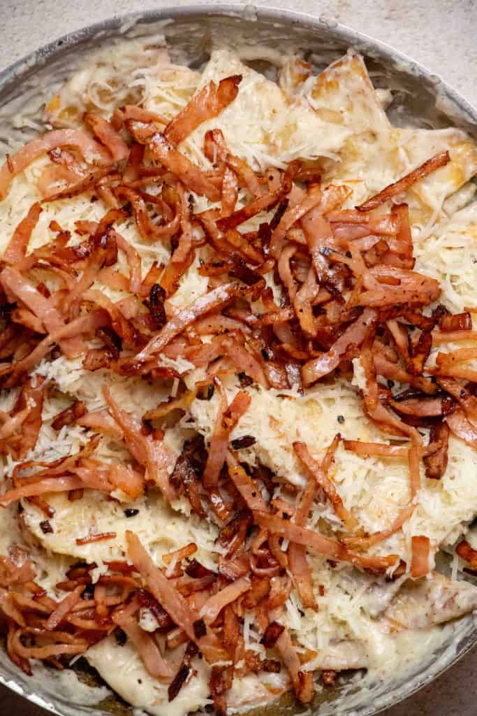 top with remaining gruyere and crispy ham, and bake 5 minutes. Prepare eggs while it bakes