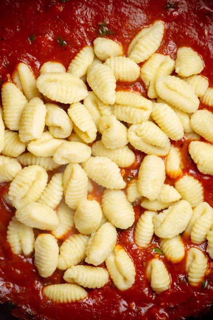 add cooked and drained gnocchi to the pan with the sauce.