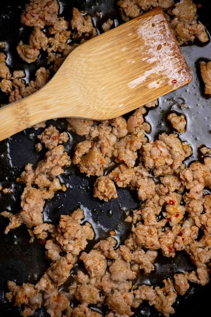 heat olive oil in a large skillet, and cook sausage, crumbling as you cook