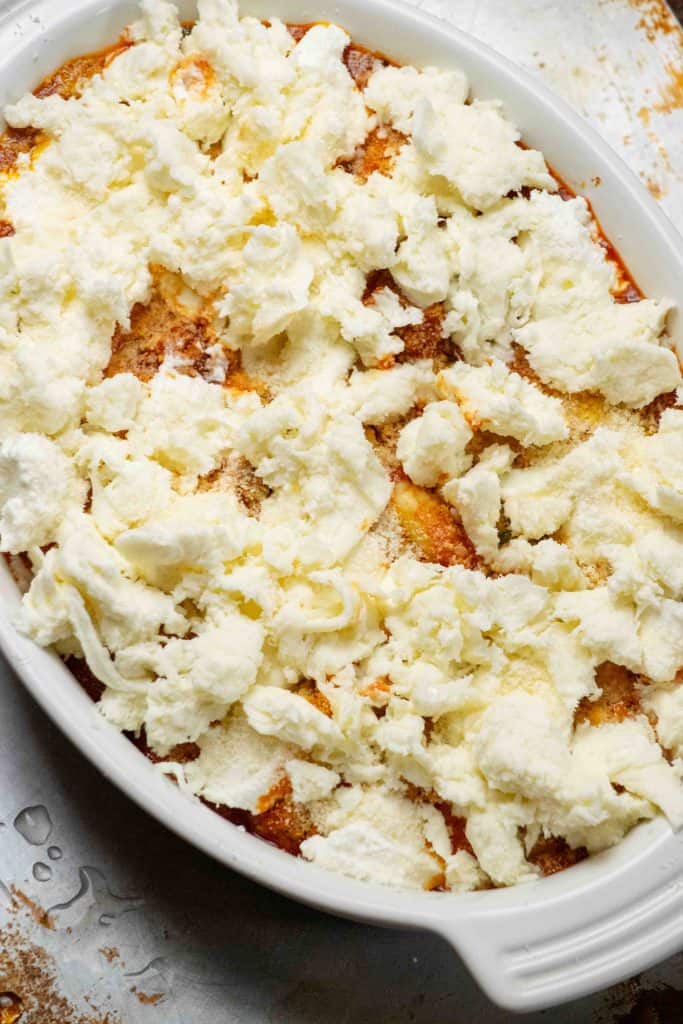 Top with torn fresh mozzarella and bake in preheated oven on top rack. 