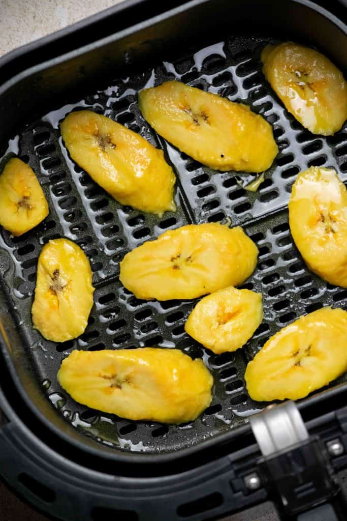spray the air fryer basket, and place plantain slices in in a single layer