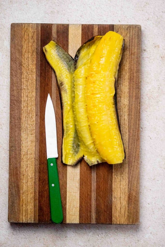 make a slit lengthwise down the skin and carefully remove it