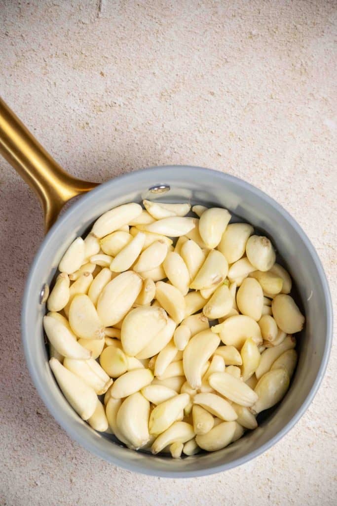 peel garlic and discard all skins. Add to a small saucepan.