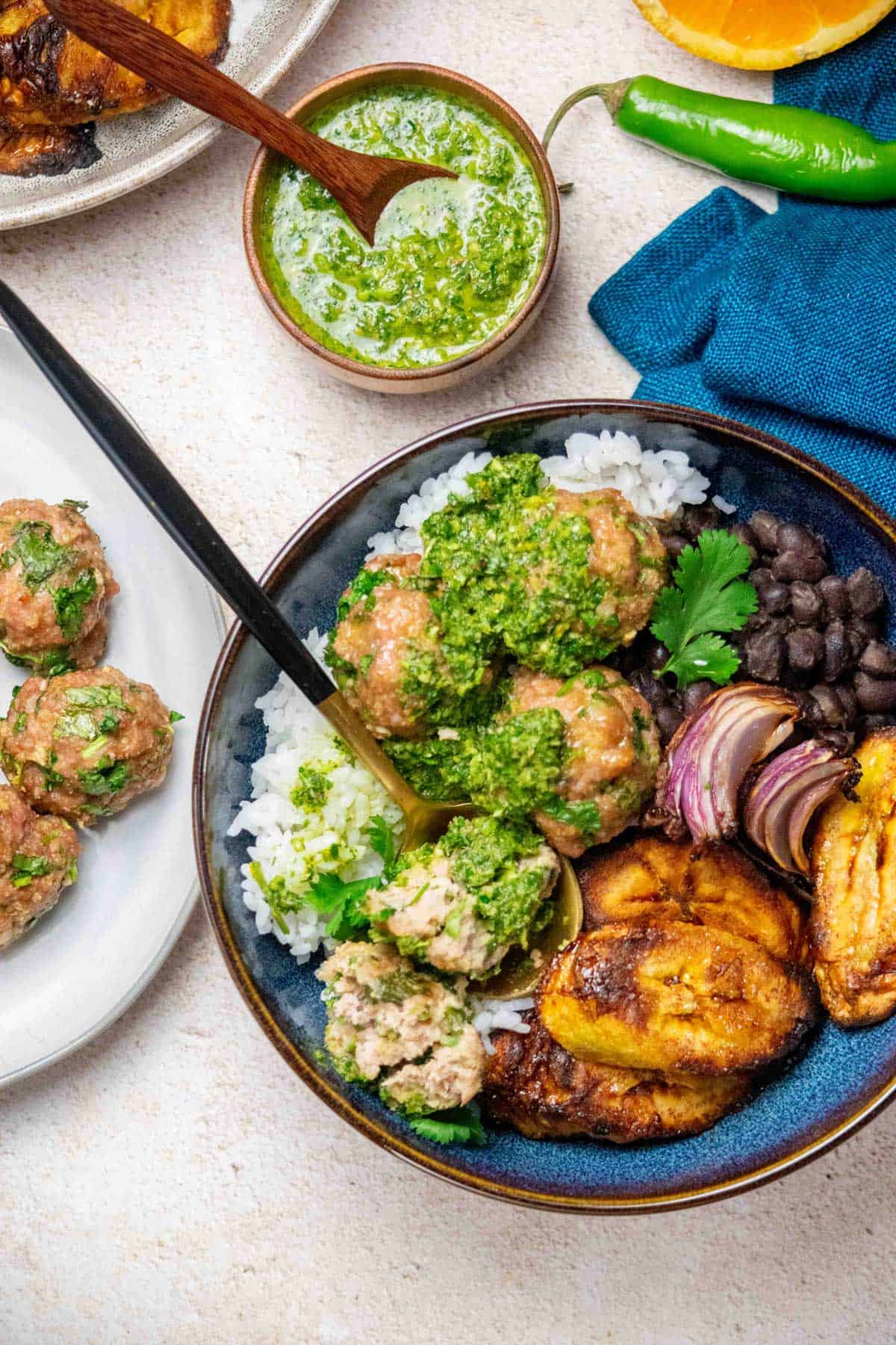 Bowl of Cuban Mojo Meatballs with rice beans and plantains