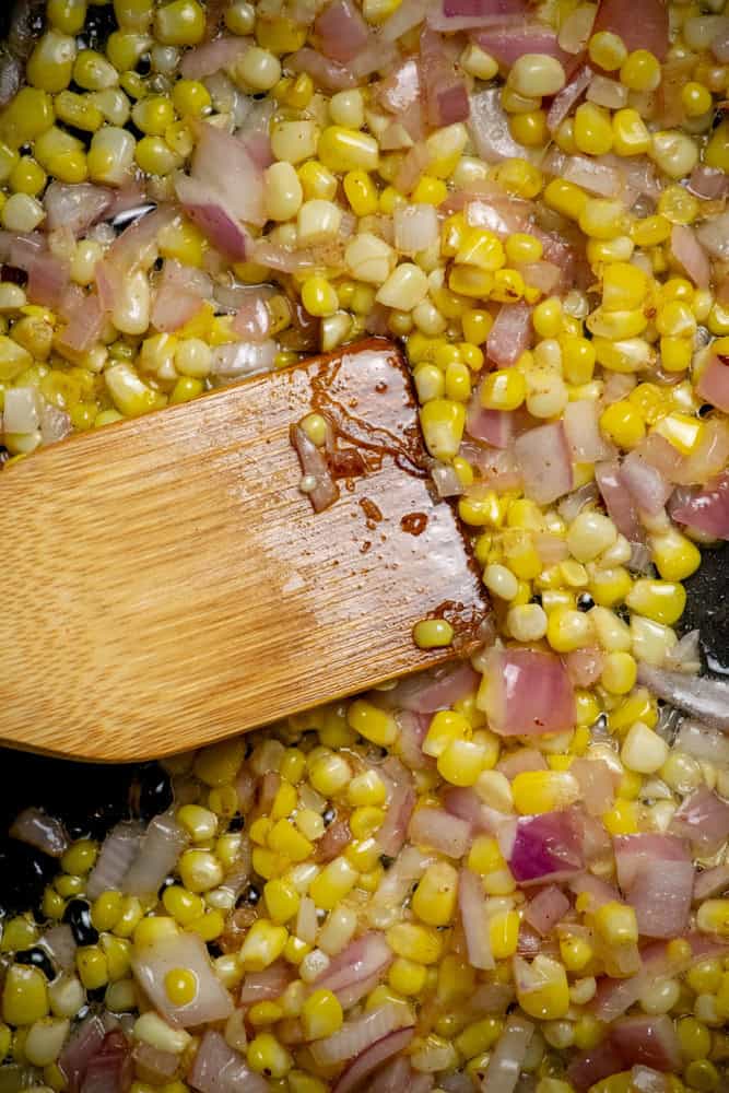 cook the bacon, remove and drain, then add red onion, corn to the pan with the bacon fat, and cook until softened