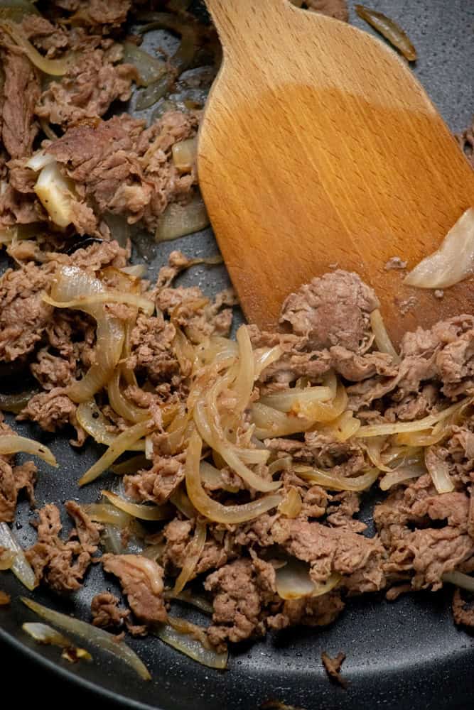 cook onions, then add steak and cook until browned