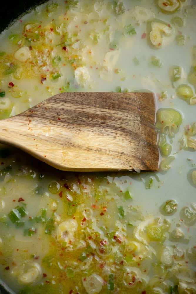 add wine and clam juice and simmer