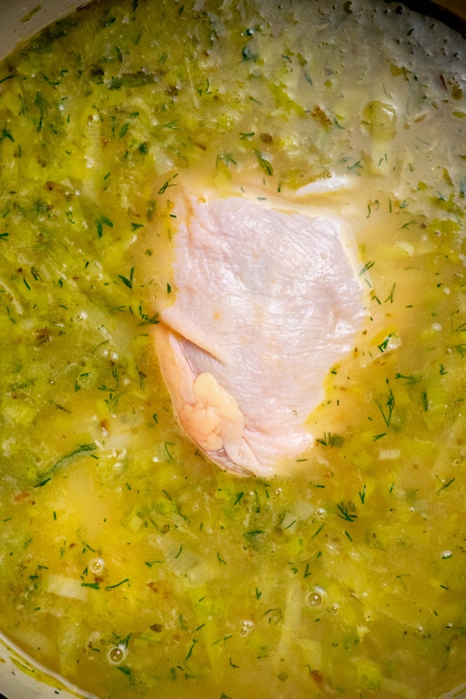 stir in chicken stock, then add chicken thighs and salt and cover and cook through