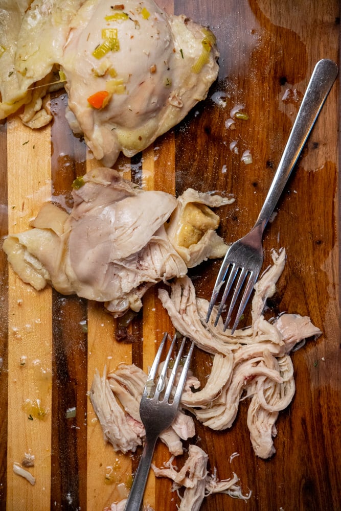 once chicken is cooked, shred meat and return to pot