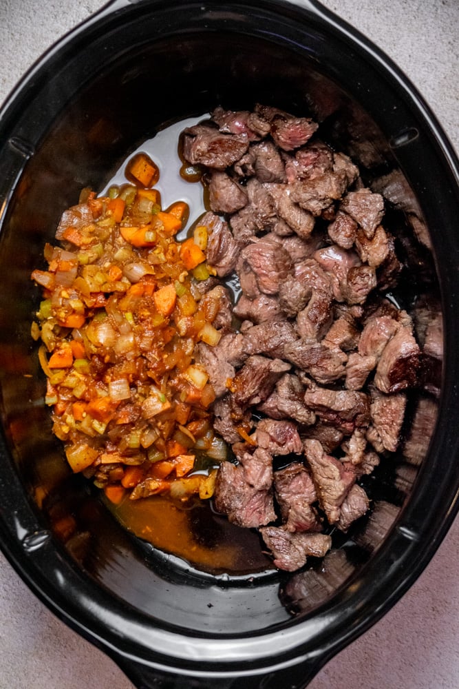 Transfer the veggie mixture to the crockpot with the browned beef. 