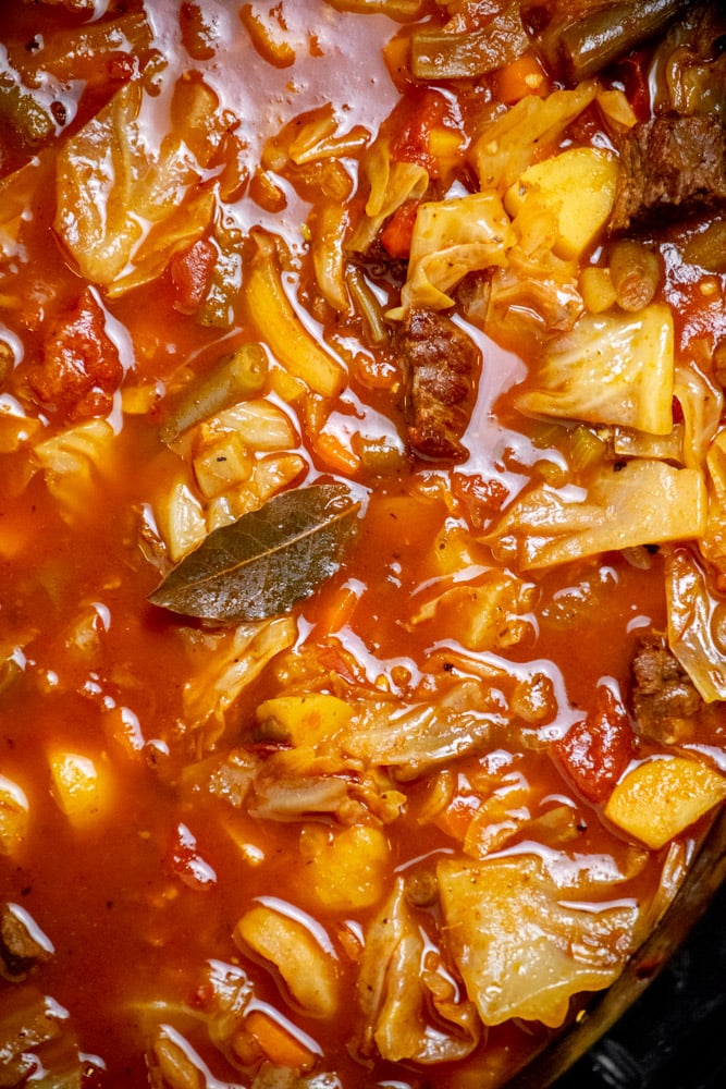 Cook on low for 8-9 hours, until veggies are tender, cabbage is softened, and meat is tender. Remove bay leaf. 