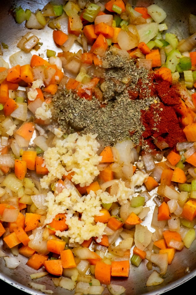add the garlic and spices to the pan and stir well, then cook for 30 seconds until its nice and fragrant. 