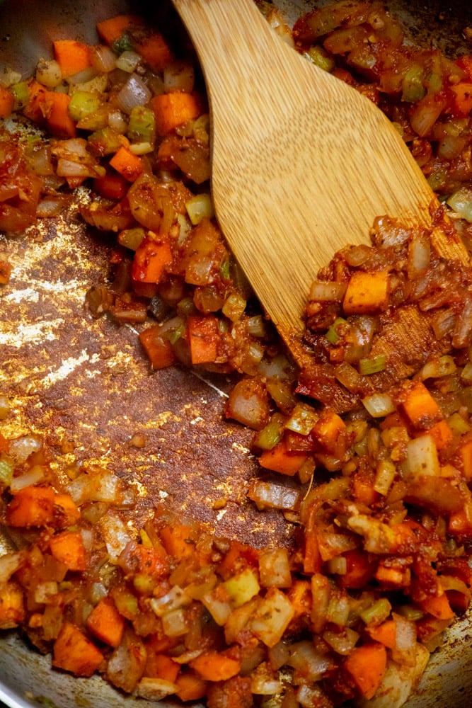 Add the tomato paste to the pot and stir well. Cook for 2 minutes until it takes on a deeper color. 