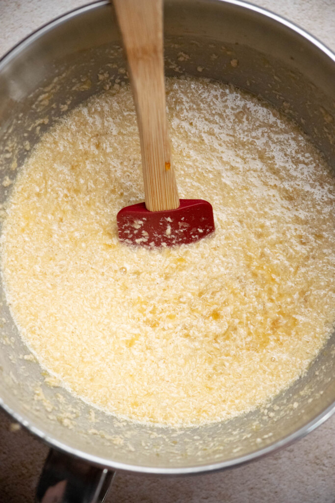 With a spatula, fold reserved pineapple juice and processed pineapple into the egg, sugar and butter mixture. It will look a little curdled- but that's OK!