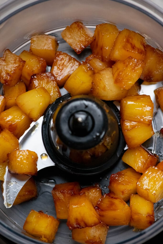 Add cooled caramelized pineapple to a food processor with blade.