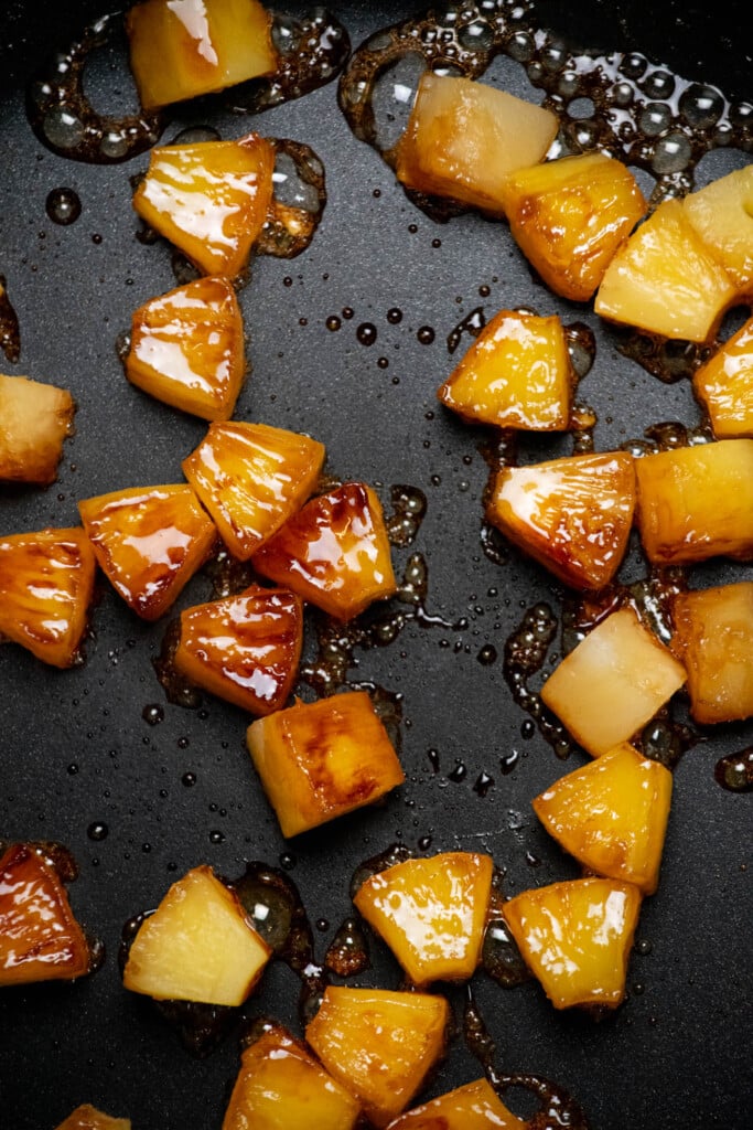 Cook the pineapple on one side until browned and caramelized, 4-5 minutes, then flip over and cook 2 minutes more. Set aside in a small bowl to cool.