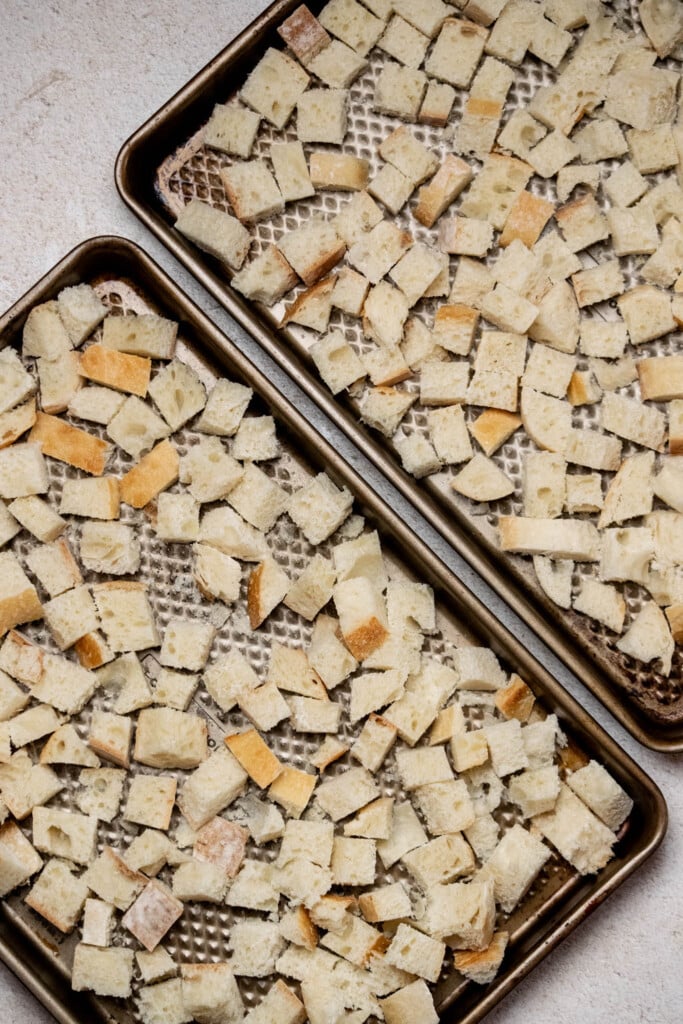 Cut your bread into about ½" cubes, and lay out on 1-2 baking sheets with no overlap. Toast for 10-15 minutes, until crisp, but still a bit soft.