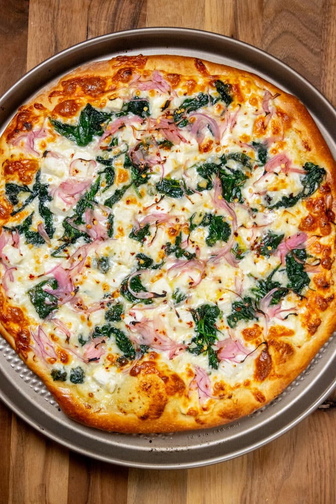 Bake the pizza in your preheated oven for 12-15 minutes, turning clockwise halfway through to promote even browning.