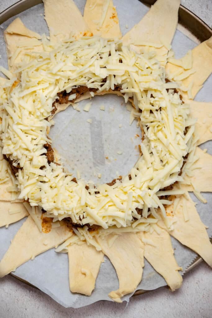 top with a layer of shredded cheddar cheese. 