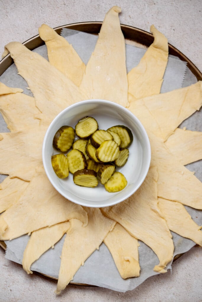 arrange the second package of crescent rolls over top, overlapping the first layer to prevent gaps. 