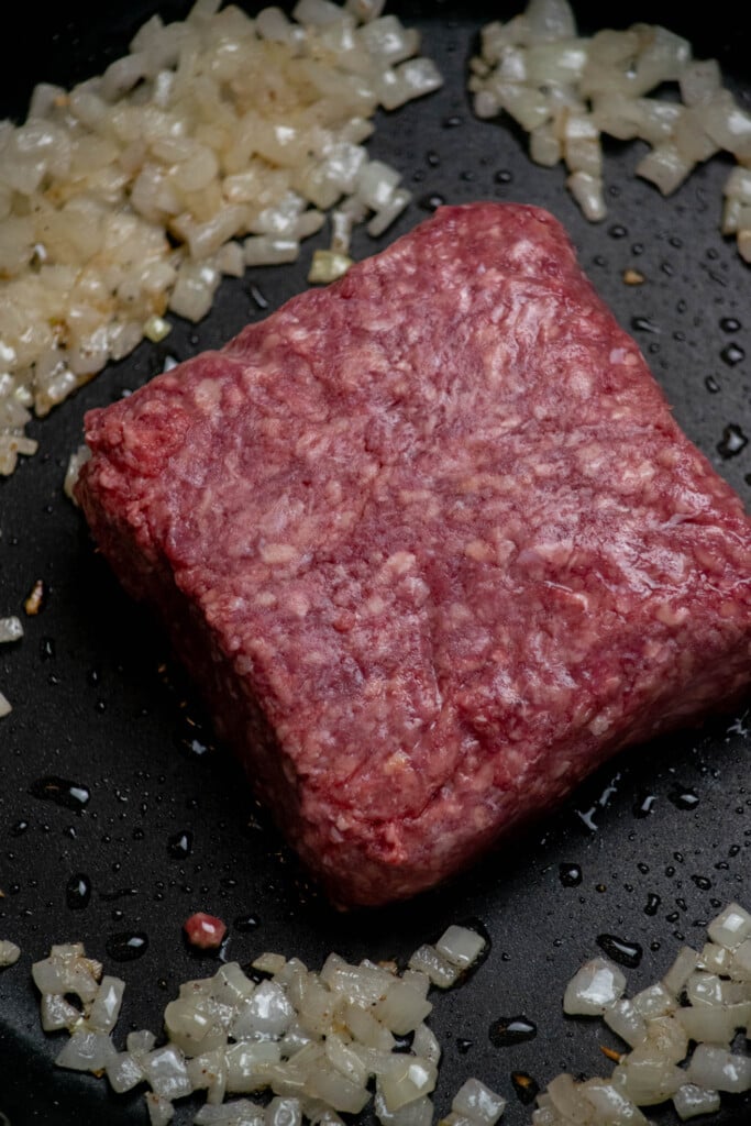 Cook onions in oil in a large skillet with salt and pepper until softened, then add in your ground beef.